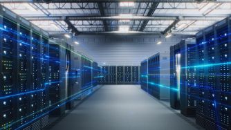 Inside a data center with rows of server racks and blue LED lights.