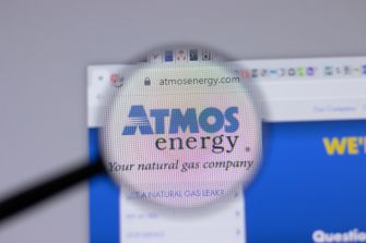 Magnifying glass over a computer screen highlighting the Atmos Energy logo.