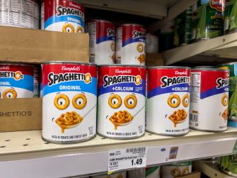 Cans of Campbell’s SpaghettiOs on store shelves in a supermarket.