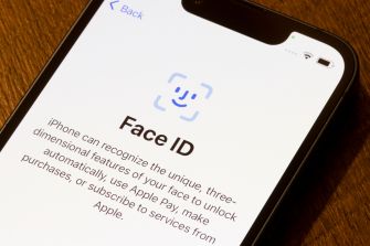 Close-up of an iPhone screen displaying the Face ID setup interface with a blue biometric icon.