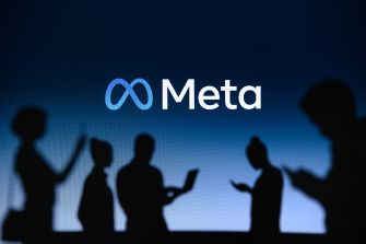 Meta logo on a blue gradient background with silhouetted people in the foreground.