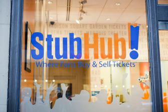 StubHub storefront window with the blue and orange StubHub! logo and the slogan “Where Fans Buy & Sell Tickets.”