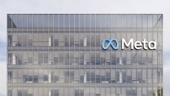 Exterior view of a glass office building with the Meta logo.
