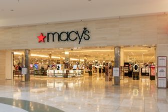 Macy’s department store interior with bright lighting and shoppers browsing near the entrance.