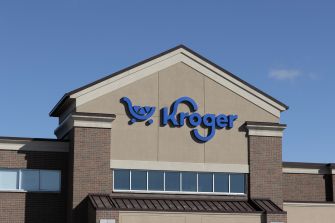 Exterior view of a Kroger supermarket storefront with the Kroger logo displayed on the building.