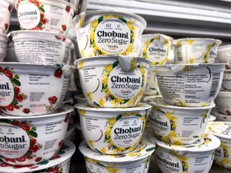 Stacks of Chobani Zero Sugar yogurt cups with vanilla flavor on a grocery-store display.