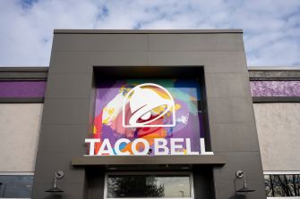Front view of a Taco Bell restaurant storefront with a large sign above the entrance.