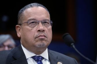 Keith Ellison, Minnesota attorney general, seated in a suit at a microphone during a federal court hearing.