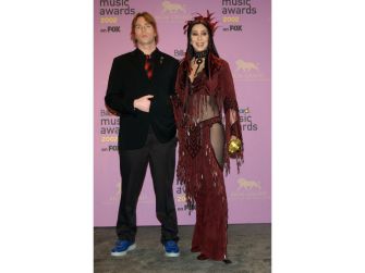 Elijah Blue Allman and his wife Marieangela King Allman pose together on a pink backdrop at a music awards event.