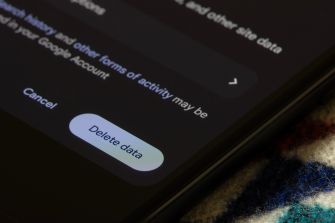 Close-up of a smartphone screen displaying a Delete data confirmation dialog with a Cancel button, illustrating data erasure on a device.