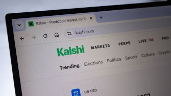 Laptop screen displaying Kalshi's online prediction market site, featuring the Kalshi logo and browser navigation tabs.