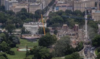Aerial view of the White House complex in Washington, D.C., showing construction activity with a tall crane at the site where a roughly 90,000-square-foot above-ground ballroom is being built.