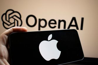 Hand holding an iPhone displaying the Apple logo, with an OpenAI logo visible in the background.