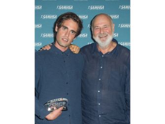 Nick Reiner and his father, filmmaker Rob Reiner, pose together at an event.