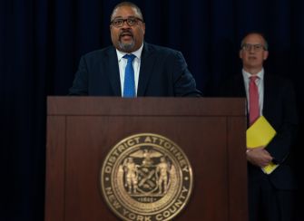 Manhattan District Attorney Alvin Bragg speaks at a podium bearing the New York County District Attorney seal.