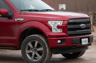 Red Ford F-150 pickup truck parked outdoors.