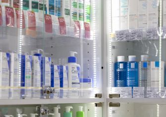CeraVe and La Roche-Posay skincare products displayed in a glass retail cabinet.