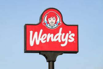 Wendy’s roadside sign against a clear blue sky.