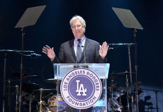 Mark Walter speaks at a podium bearing the Los Angeles Dodgers Foundation logo.