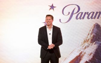 Paramount CEO David Ellison stands onstage in front of a Paramount logo.