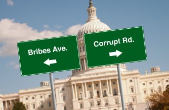 Road signs labeled “Bribes Ave.” and “Corrupt Rd.” point in opposite directions in front of the U.S. Capitol.