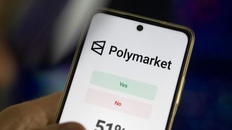 Smartphone displaying the Polymarket app with green “Yes” and red “No” prediction buttons.