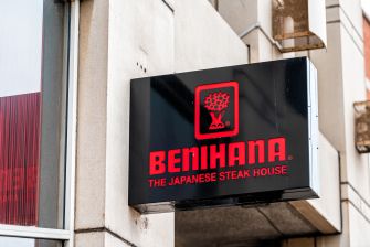 Benihana: The Japanese Steakhouse sign mounted on the exterior of a restaurant building.