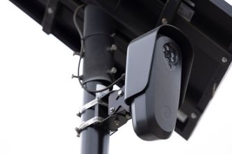 Automated license plate reader camera mounted on a roadside pole.