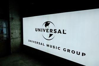 Universal Music Group logo projected on a large screen in a dark room.