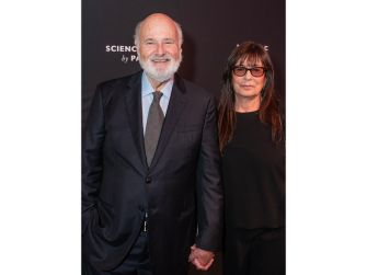 Rob Reiner and Michele Reiner pose together in formal attire, holding hands at an event.