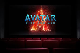 Cinema screen displaying the “Avatar: Fire and Ash” title logo above rows of empty theater seats.