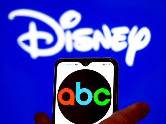 Smartphone displaying the ABC logo in front of a Disney logo.