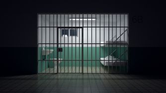 Illustration of a barred prison cell with a bed and sink, representing Caleb Flynn’s life-without-parole sentence.