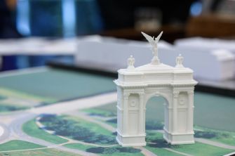 Scale model of the proposed 250-foot Independence Arch displayed on a map near Arlington National Cemetery.