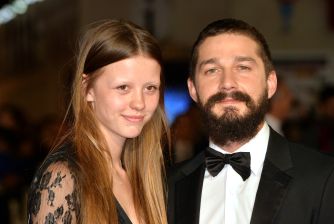 Mia Goth and Shia LaBeouf pose together at a formal event.