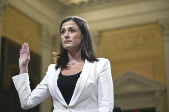 Cassidy Hutchinson raises her hand while testifying at a congressional hearing.