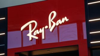 Ray-Ban storefront sign mounted on a red facade.