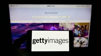 Getty Images logo displayed on a smartphone in front of the Getty Images website.