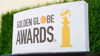 Golden Globe Awards sign displayed outdoors on a grassy background.
