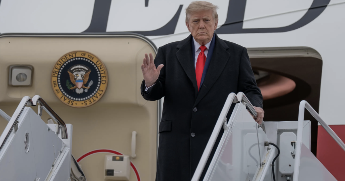 President Donald Trump waves while descending the stairs of a U.S. government aircraft