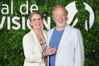 Timothy Busfield poses with a woman at a green-carpet event.