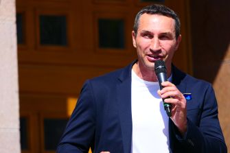Wladimir Klitschko speaks into a microphone at a public event.