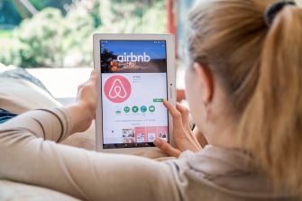 Traveler viewing an Airbnb listing on a tablet.