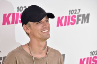 Aaron Carter smiles while posing at a 102.7 KIIS FM event.