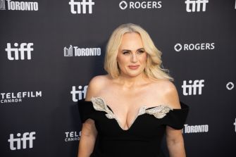 Rebel Wilson poses in a black off-the-shoulder dress at a Toronto International Film Festival event.