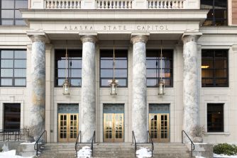 Alaska State Capitol building in Juneau, with snow-covered steps and columns at the main entrance.