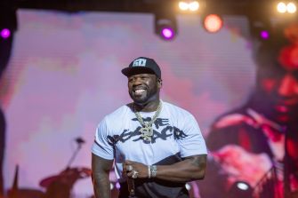 Rapper 50 Cent, also known as Curtis Jackson, smiles while performing onstage.