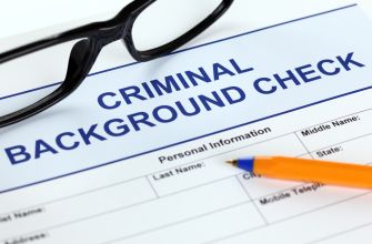 Criminal background check form labeled “Criminal Background Check” with eyeglasses and an orange pencil.
