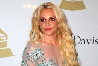 Image of a woman with long blonde hair wearing a sparkling dress, appearing at a formal event.
