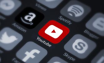 YouTube app icon surrounded by various social media and streaming service icons.